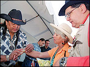 Jesse Monongye, a jeweler at the Indian Market in Sante Fe, N.M., shows a bracelet to Catherine Wygant and her husband, Dan Monroe.