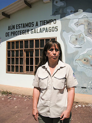 Raquel Molina, the director of Galápagos National Park, stands in front of a mural at park headquarters that says, “There is still time to protect the Galápagos.” ©Joshua Brockman 2007. All Rights Reserved.