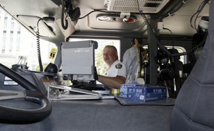 Oklahoma City Battalion Chief Glenn Clark uses a laptop to obtain information using the city's Wi-Fi network. Police officers and firefighters are able to view real-time images from hundreds of cameras located throughout the city, even if they are far from those locations.