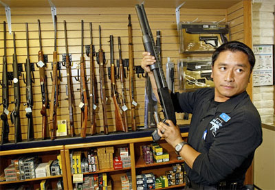 Heu Thao shows a customer a shotgun at the Gun Store in Las Vegas in November. Gun sales skyrocketed around the time of Barack Obama's election.