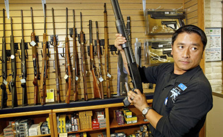 Heu Thao shows a customer a shotgun at the Gun Store in Las Vegas in November. Gun sales skyrocketed around the time of Barack Obama's election.