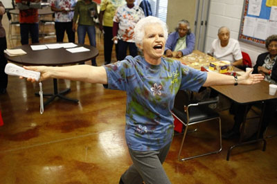 Sofia Henriquez, 76, celebrates after scoring in the Wii bowling competition. In addition to singing and dancing during the game, she cheered on her teammates with a noisemaker crafted from a soda bottle filled with pebbles.