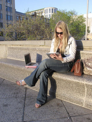 Leslie Bradshaw displays her iPad and MacBook Air -- some of the wireless devices she carries with her. Bradshaw -- who doesn't have a land line, high-speed Internet or subscription TV at home -- describes herself as a "digital gypsy."