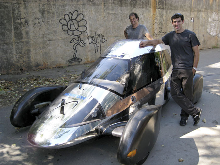 Team Edison2's Oliver Kuttner (left) and Brad Jaeger, one of the team's professional race car drivers, with the Very Light Car that won the mainstream class of the X Prize competition. Joshua Brockman/NPR.