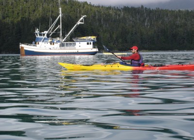 Ben Kyle paddles at dusk near the mother ship Home Shore during a seven-day circumnavigation of Chichagof Island in Southeast Alaska. ©Joshua Brockman 2005. All Rights Reserved.)