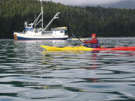 Ben Kyle paddles at dusk near the mother ship Home Shore during a seven-day circumnavigation of Chichagof Island in Southeast Alaska. ©Joshua Brockman 2005. All Rights Reserved.)