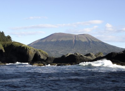 Waves crash into St. Lazaria National Wildlife Refuge with Mt. Edgecumbe, a dormant volcano, looming in the background. ©Joshua Brockman 2005. All Rights Reserved.