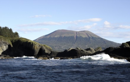 Waves crash into St. Lazaria National Wildlife Refuge with Mt. Edgecumbe, a dormant volcano, looming in the background. ©Joshua Brockman 2005. All Rights Reserved.