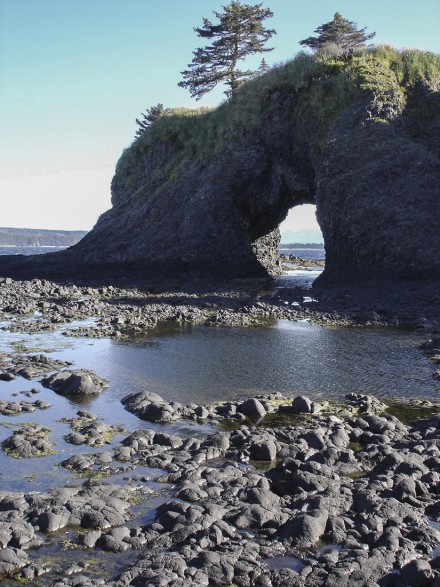 A large rock arch in St. Lazaria National Wildlife Refuge frames the view out to Sitka Sound. ©Joshua Brockman 2005. All Rights Reserved.