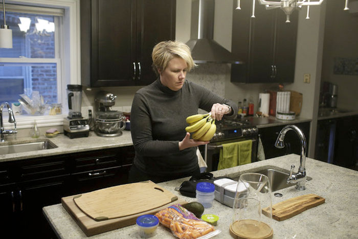 Gabrielle Novacek, a frequent business traveler, preparing food at home for a coming flight. Joshua Lott for The New York Times.