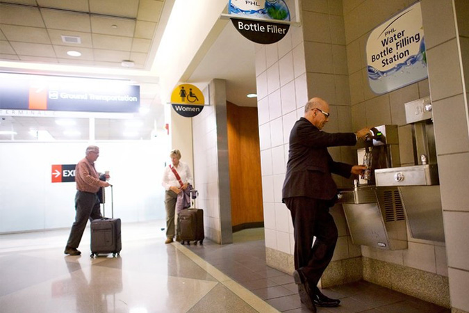 Dr. Stephen Klasko, chief executive of Thomas Jefferson University and Jefferson Health, who typically travels two or three times a week, refilling his water bottle at a station in Philadelphia International Airport. Credit Mark Makela for The New York Times.