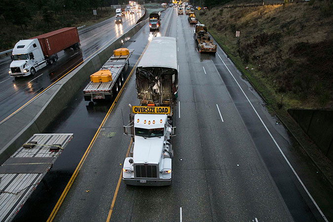 A truck carrying one of the wrecked rail cars from the Amtrak derailment